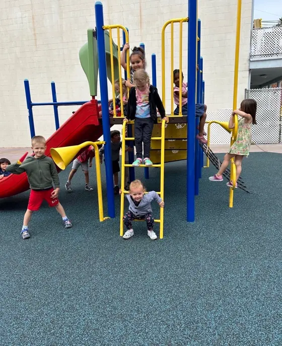 Children climbing on the playground structure